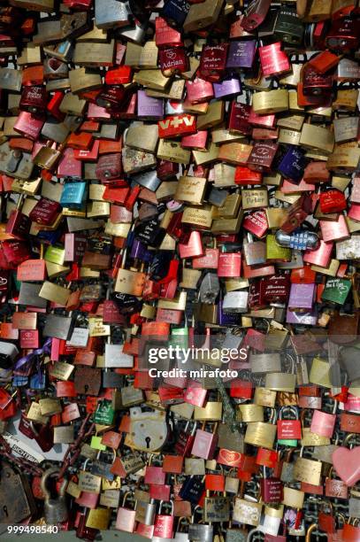 love locks on the railing of the hohenzollern bridge, cologne, north rhine-westphalia, germany - cologne germany stock pictures, royalty-free photos & images