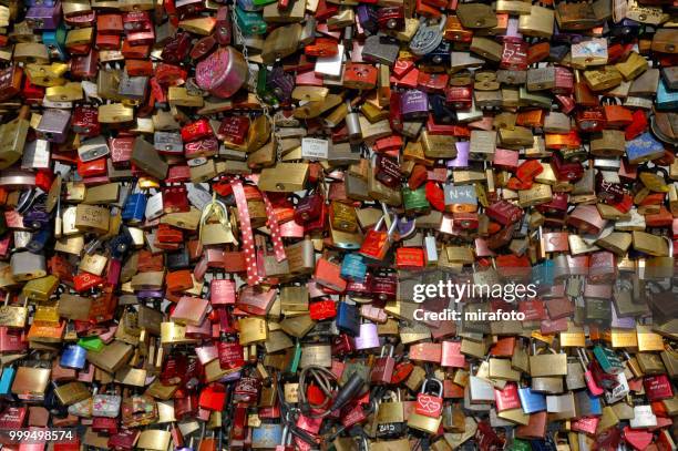 love locks on the railing of the hohenzollern bridge, cologne, north rhine-westphalia, germany - cologne germany stock pictures, royalty-free photos & images