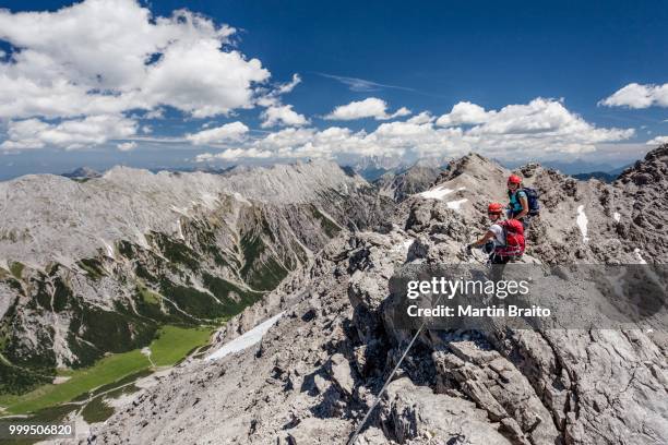 hikers on the summit ridge during the ascent through the imster via ferrata on the maldonkopf in the lech valley alps, hochimst, imst, tyrol, austria - lechtal alps stock pictures, royalty-free photos & images