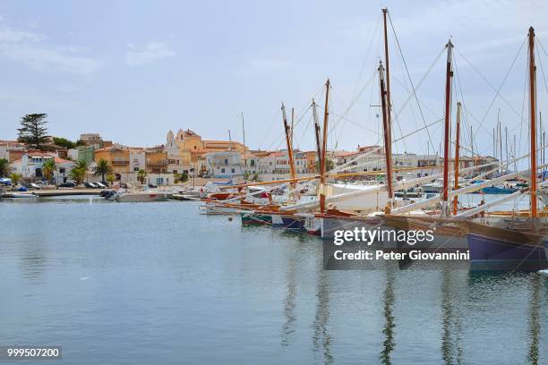 traditional sailing boats with lateen sail, vela latina, in the port of calasetta, isola di sant'antioco, province of carbonia-iglesias, sardinia, italy - isola stock pictures, royalty-free photos & images