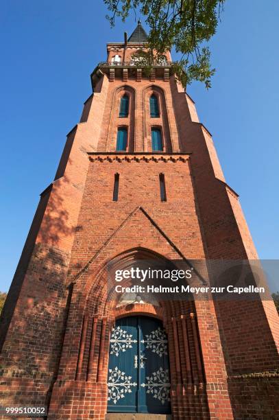 tower of the neo-gothic parish church of wustrow, 1873, mecklenburg-western pomerania, germany - driveway gate stock pictures, royalty-free photos & images