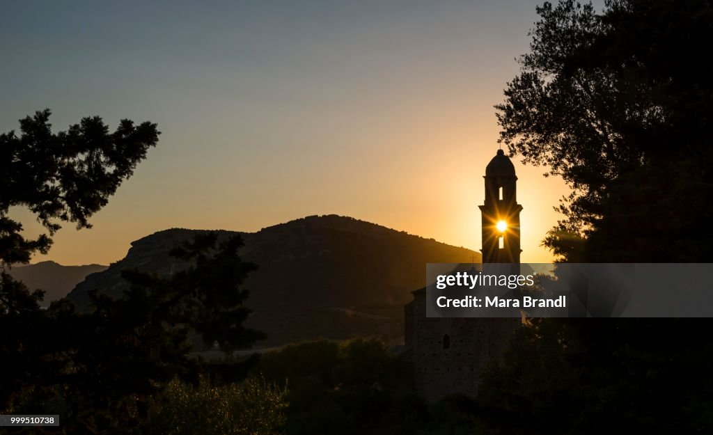 Sun shining through a belfry, silhouette of a church tower, evening mood, sunset, Haute-Corse, Corsica, France