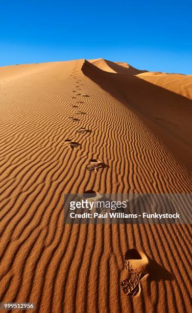 footsteps in the sahara sand dunes of erg chebbi, morocco - sahara stock pictures, royalty-free photos & images