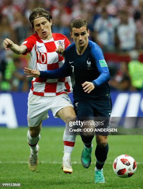 Croatia's midfielder Luka Modric and France's forward Antoine Griezmann vie for the ball during the Russia 2018 World Cup final football match...