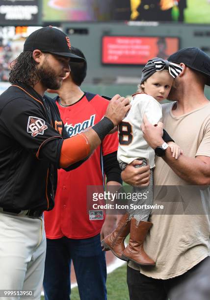 San Francisco Giants shortstop Brandon Crawford signs the jersey of a young fan prior to the start of the game in an MLB game between the San...