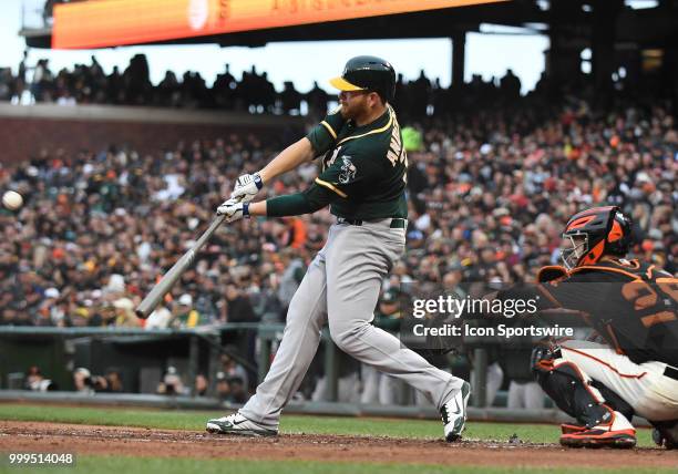 Oakland Athletics starting pitcher Brett Anderson slaps a base hit to left field in an MLB game between the San Francisco Giants and Oakland...