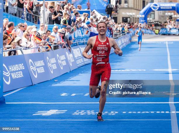 July 2018, Germany, Hamburg: Adrien Briffod from Switzerland crossing the finish line of the Triathlon Mixed Relay World Championship. Photo: Markus...