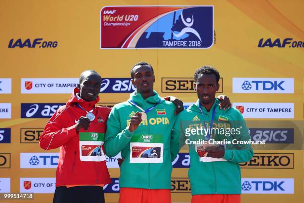 Leonard Kipkemoi Bett of Kenya, Takele Nigate of Ethiopia and Getnet Wale of Ethiopia celebrate with their medals during the medal ceremony for the...