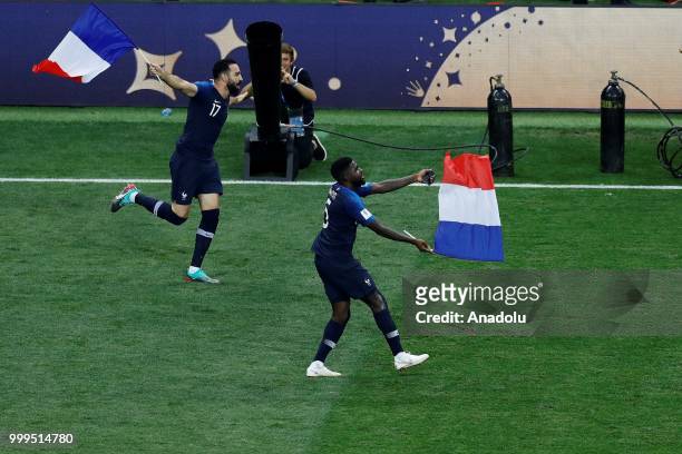Adil Rami and Samuel Umtiti of France wave France's national flags as they celebrate FIFA World Cup championship after the 2018 FIFA World Cup Russia...