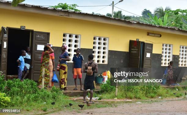 This picture taken on July 14, 2018 shows people who found shelter at a school after their neighbourhood was flooded duribg heavy rainfall in...