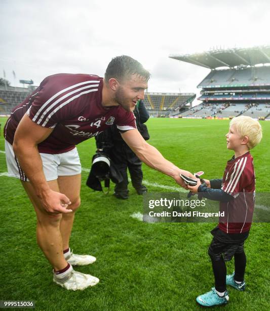 Dublin , Ireland - 15 July 2018; Galway captain Damien Comer gives his gloves to young Galway supporter Rian Sheridan, age 4, after the GAA Football...