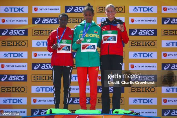 Miriam Cherop of Kenya, Alemaz Samuel of Ethiopia and Delia Sclabas of Switzerland celebrate with their medals during the medal ceremony for the...
