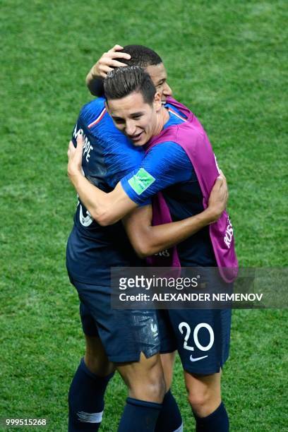 France's forward Kylian Mbappe celebrates with France's forward Florian Thauvin after scoring a goal during the Russia 2018 World Cup final football...