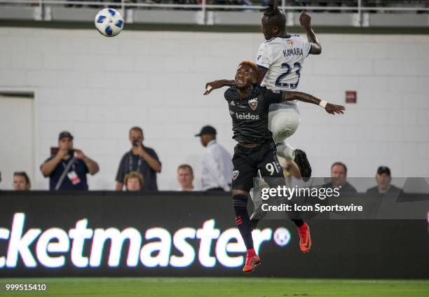 Vancouver Whitecaps forward Kei Kamara heads over D.C. United midfielder Oniel Fisher during a MLS match between D.C. United and the Vancouver...