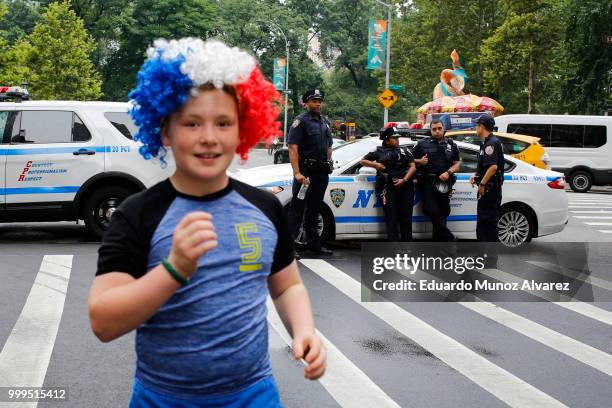 Officers stand guard on the street as fans arrive to watch the World Cup final match between France and Croatia on July 15, 2018 in New York City....