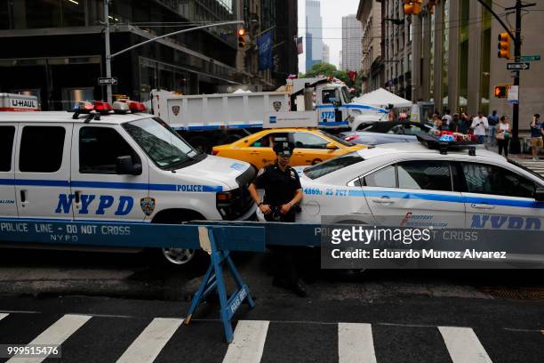 Officers stand guard on streets as fans arrive to watch the World Cup final match between France and Croatia on July 15, 2018 in New York City....