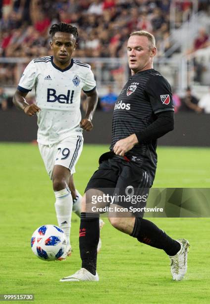 United forward Wayne Rooney slips a pass away from Vancouver Whitecaps forward Yordi Reyna during a MLS match between D.C. United and the Vancouver...