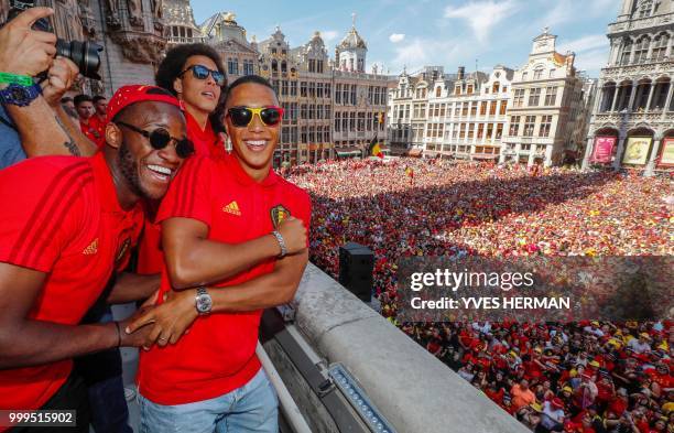 Belgium's players Michy Batshuayi, Axel Witsel and Youri Tielemans celebrate at the balcony in front of more than 8000 supporters at the Grand-Place,...
