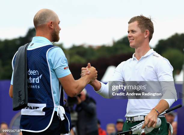 Brandon Stone of South Africa shakes hands with his caddie after finishing his round on 20 shots under par during day four of the Aberdeen Standard...