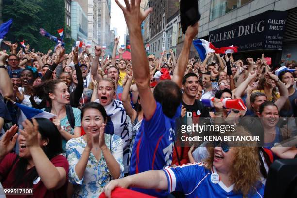 French fans react as France scores a goal, while they watch the World Cup final match between France vs Croatia on July 15, 2018 in New York. - The...