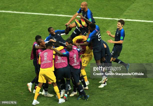 The France team lift Paul Pogba of France as they celebrate winning the World Cup during the 2018 FIFA World Cup Russia Final between France and...