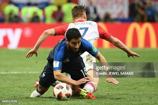 Croatia's midfielder Ivan Rakitic fouls France's midfielder Nabil Fekir during the Russia 2018 World Cup final football match between France and...
