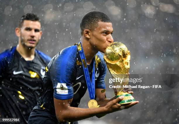 Kylian Mbappe of France kisses the World Cup trophy following the 2018 FIFA World Cup Final between France and Croatia at Luzhniki Stadium on July...