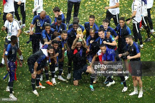 Adil Rami of France and his teammates celebrate with the World Cup Trophy following their sides victory in the 2018 FIFA World Cup Final between...