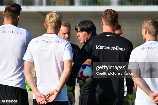 Germany's national coach Joachim Loew is talking to his players during a training session of the German national soccer team on the training grounds...