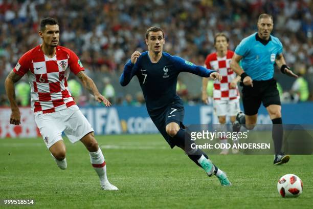 Croatia's defender Dejan Lovren and France's forward Antoine Griezmann vie for the ball during the Russia 2018 World Cup final football match between...