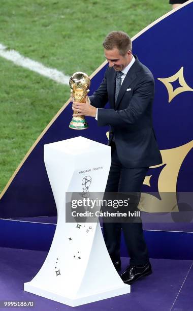 Former football player Philippe Lahm takes the World Cup trophy on the stage for the winning ceremony following during the 2018 FIFA World Cup Final...