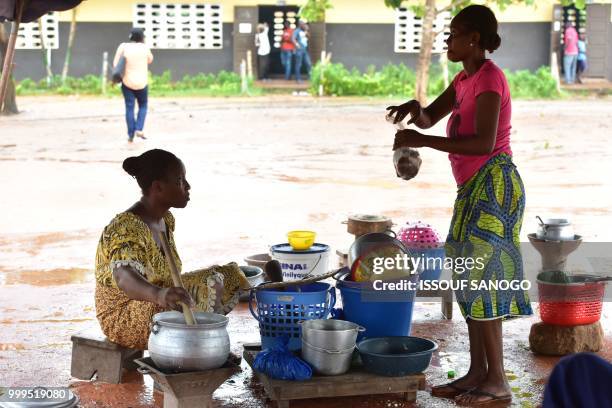 This picture taken on July 14, 2018 shows people who found shelter at a school after their neighbourhood was flooded duribg heavy rainfall in...