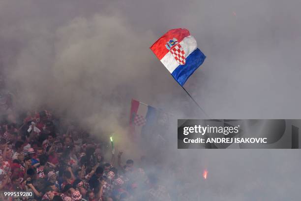 Croatian supporters cheer in downtown Zagreb on July 15 ahead of the 2018 Russia World Cup final football match between Croatia and France, the first...