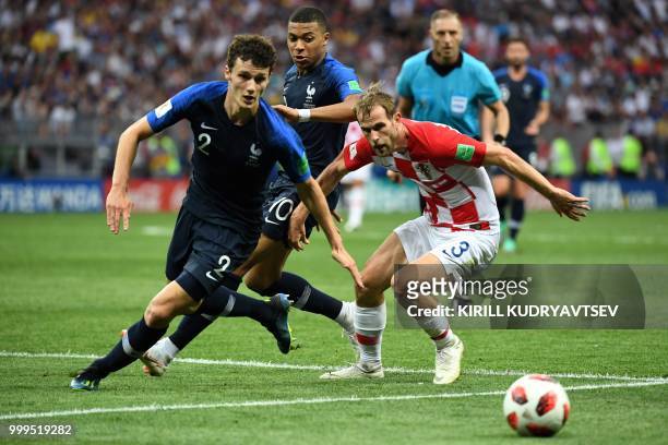 Croatia's defender Ivan Strinic vies with France's defender Benjamin Pavard during the Russia 2018 World Cup final football match between France and...