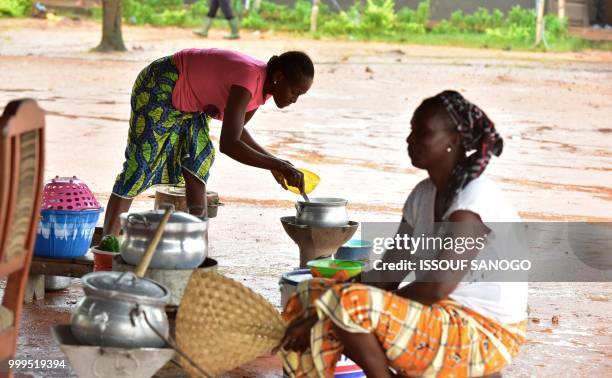 This picture taken on July 14, 2018 shows people who found shelter at a school after their neighbourhood was flooded duribg heavy rainfall in...