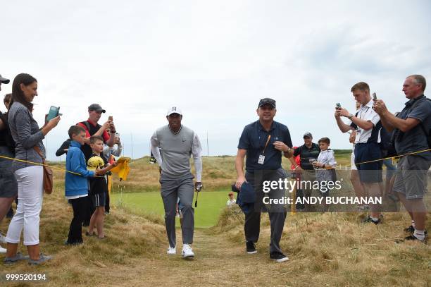 Golfer Tiger Woods walks off the 2nd green during the first practice session at The 147th Open Championship at Carnoustie, Scotland on July 15, 2018.