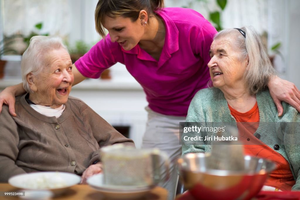 Two elderly women, 78 years and 88 years, and a carer for the elderly, 31 years, leisure activities in a nursing home