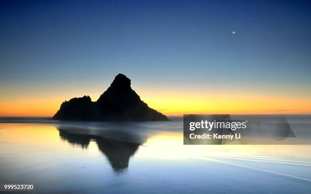 a beautiful sunset at karekare beach - kenny stock pictures, royalty-free photos & images