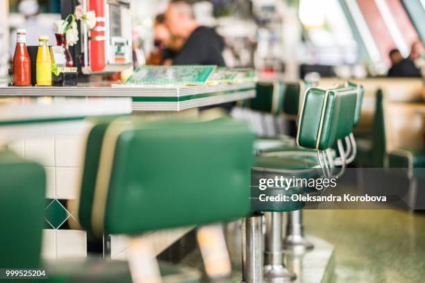 vintage padded bar stools in an american diner restaurant. - 50s diner stock pictures, royalty-free photos & images