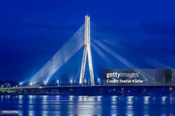 vansu bridge, cable-stayed bridge, dusk, blue hour, over the daugava river or western dvina, riga, latvia - cable stayed bridge stock pictures, royalty-free photos & images