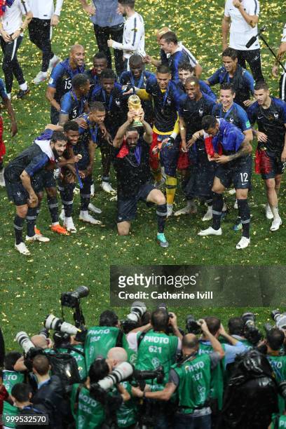 Adil Rami of France celebrates with the World Cup Trophy following his sides victory in the 2018 FIFA World Cup Final between France and Croatia at...