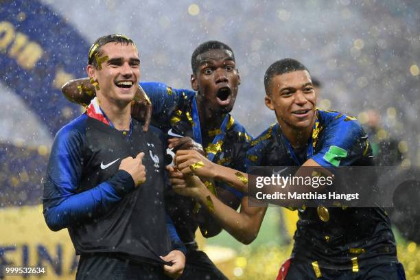 Antoine Griezmann, Paul Pogba, and Kylian Mbappe of France celebrate following their sides victory in the 2018 FIFA World Cup Final between France...