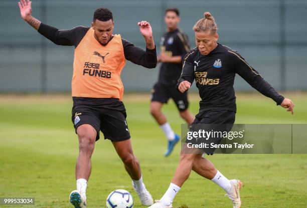 Dwight Gayle strikes the ball which is deflected by Jamaal Lascelles during the Newcastle United Training session at Carton House on July 15 in...