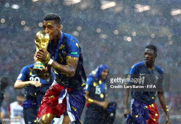 Presnel Kimpembe of France celebrates victory with the World Cup trophy following the 2018 FIFA World Cup Final between France and Croatia at...