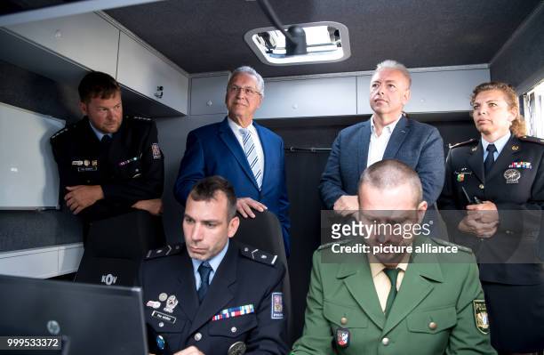 The Bavarian interior minister Joachim Herrmann and his Czech colleague Milan Chovanec can be seen watching the joint cross-border drill involving...