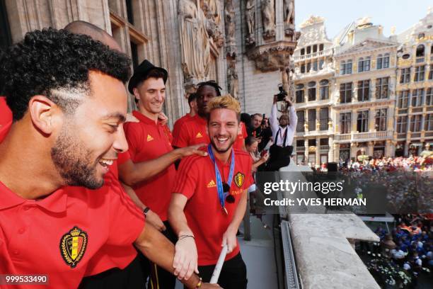 Belgian players Mousa Dembele , Thomas Meunier and Dries Mertens celebrate at the balcony in front of more than 8000 supporters at the Grand-Place,...