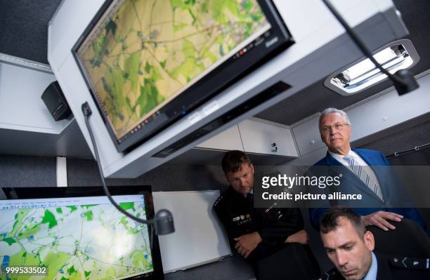 The Bavarian interior minister Joachim Herrmann can be seen watching the joint cross-border drill involving German and Czech police forces in Furth...