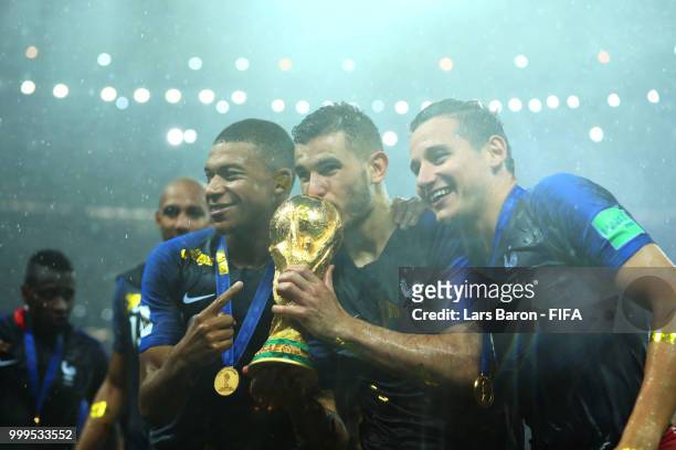 Kylian Mbappe, Lucas Hernandez and Florian Thauvin of France celebrate victory following the 2018 FIFA World Cup Final between France and Croatia at...