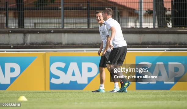 Mesut Oezil and Julian Draxler during a training session of the German men's national soccer team before a World Cup qualification match, at the...