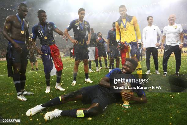 Samuel Umtiti of France celebrates victory with the World Cup trophy following the 2018 FIFA World Cup Final between France and Croatia at Luzhniki...